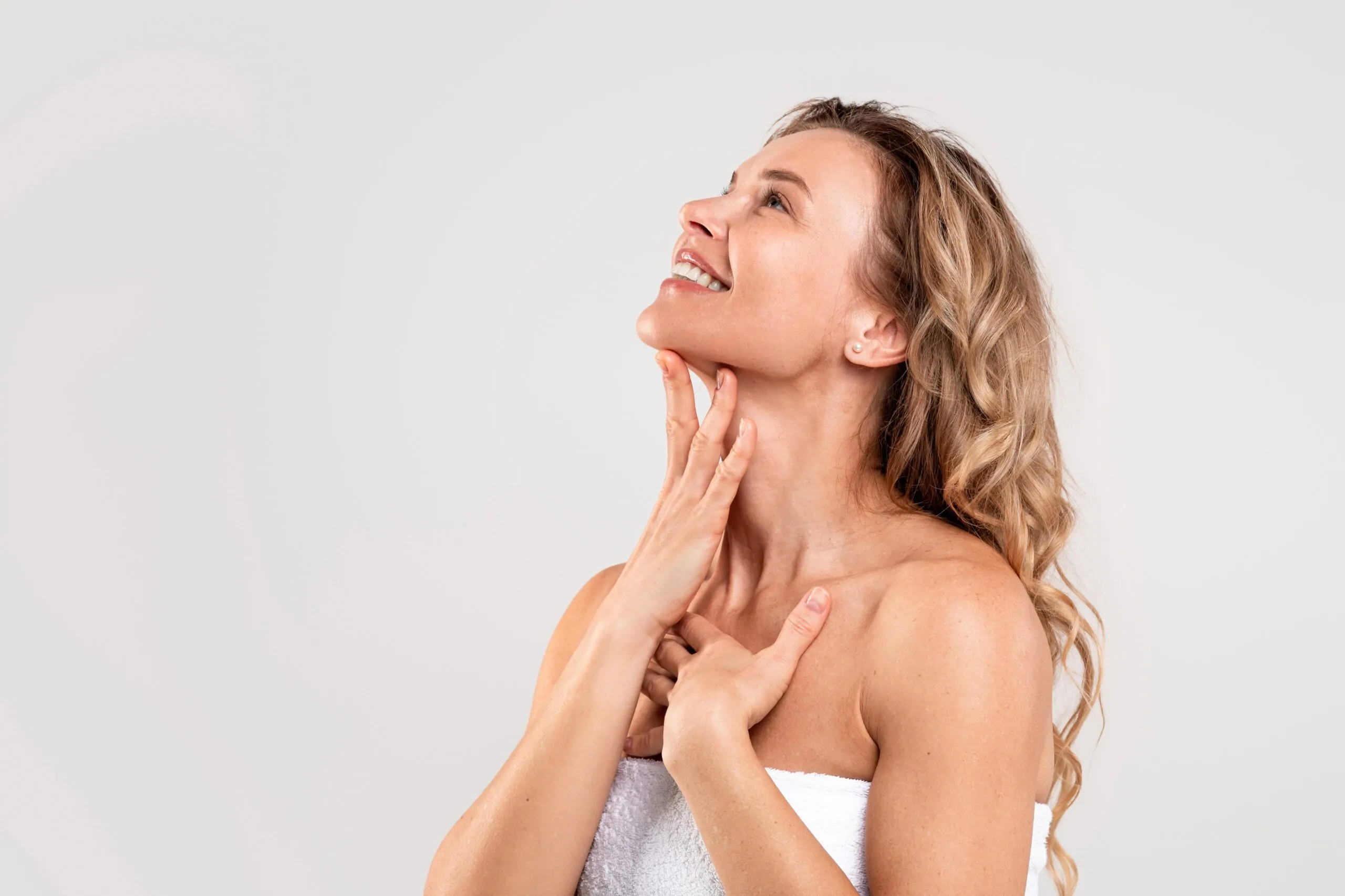 A Happy woman feeling her chin